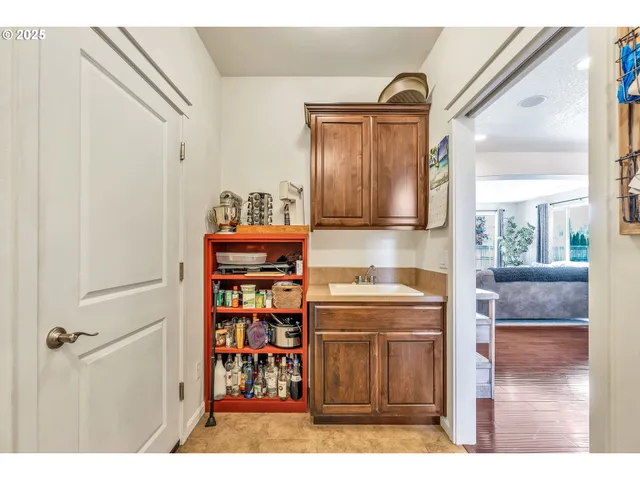 a kitchen with stainless steel appliances granite countertop a refrigerator and a wooden cabinets