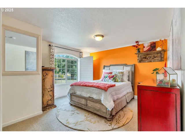 a bedroom with a bed and window