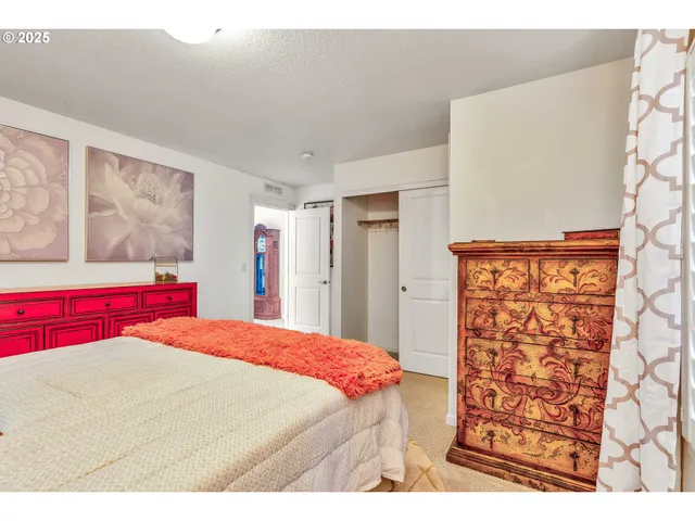 a bedroom with a large bed and a closet