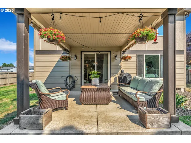 a balcony with furniture and a potted plant
