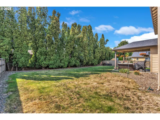 a view of a backyard with swimming pool