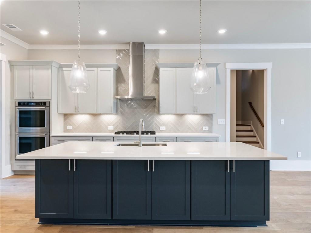 216 Ewing Way Dacula, GA 30019 - Photo 13 of 56 a kitchen with kitchen island granite countertop a sink stainless steel appliances and cabinets