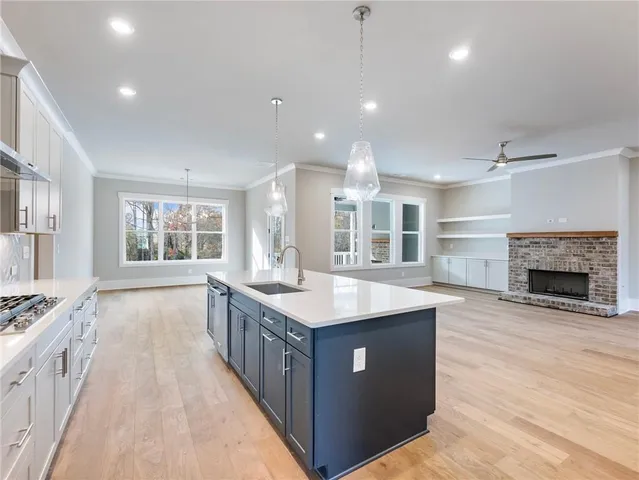 a kitchen with a sink stove and cabinets
