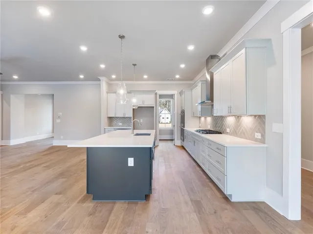 a kitchen with white cabinets and a stove