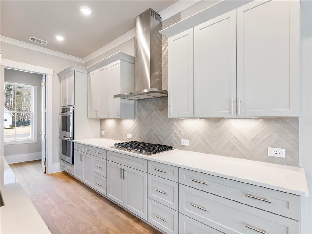 216 Ewing Way Dacula, GA 30019 - Photo 18 of 56 a kitchen with white cabinets and a stove