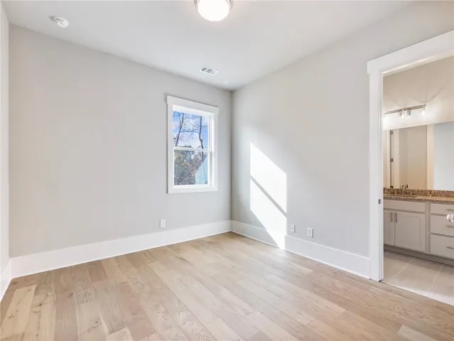 a view of a hallway with a dining table & chairs