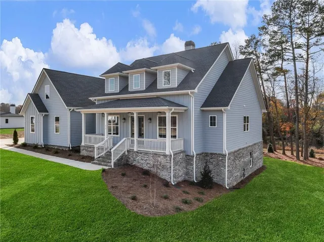 a view of a house with a yard and sitting area