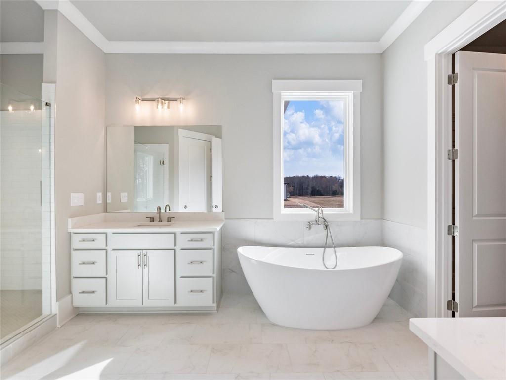 216 Ewing Way Dacula, GA 30019 - Photo 39 of 56 a spacious bathroom with a double vanity sink a mirror and a bathtub