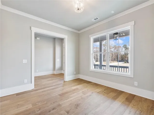 a view of a kitchen with kitchen island and wooden floor