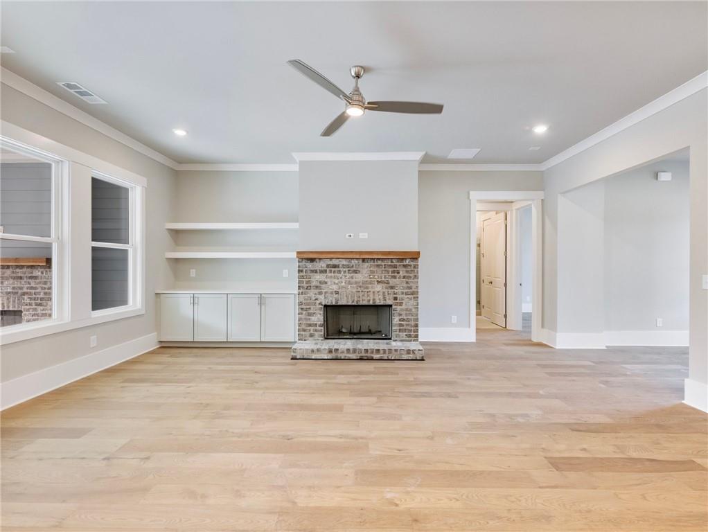 216 Ewing Way Dacula, GA 30019 - Photo 10 of 56 a view of a livingroom with a fireplace a ceiling fan and window