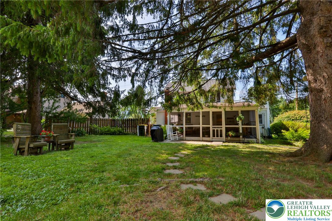 666 Point Phillips Road Bath, PA 18014 - Photo 57 of 68 A spacious backyard with mature trees provides ample shade and a screened porch offers a tranquil outdoor retreat.