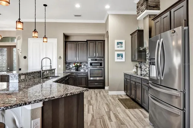 a view of a patio with table and chairs under an umbrella