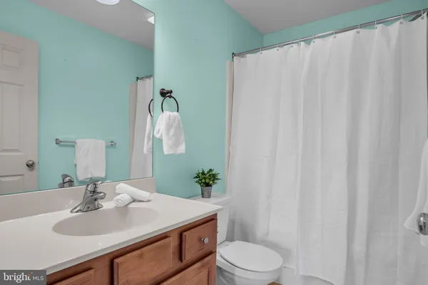 a bathroom with a sink vanity mirror and toilet