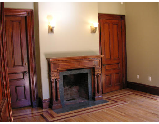 82 Herrick Road Newton, MA 02459 - Photo 5 of 12 a view of an empty room with wooden floor fireplace and a window