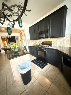 a kitchen with a sink and a stove top oven