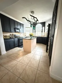 a kitchen with stainless steel appliances granite countertop a sink stove a refrigerator and a oven