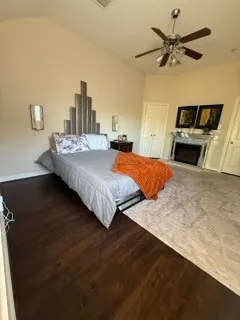 a bedroom with a bed and a ceiling fan