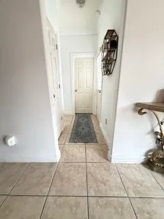a view of entryway with kitchen and a window