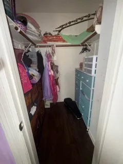 a view of walk in closet with clothes and shoes