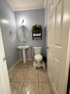 a bathroom with a toilet a sink and mirror
