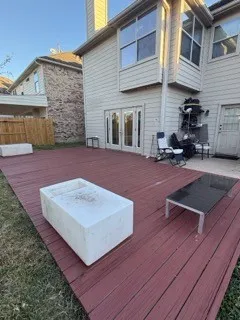 a wooden bench sitting in front of a building