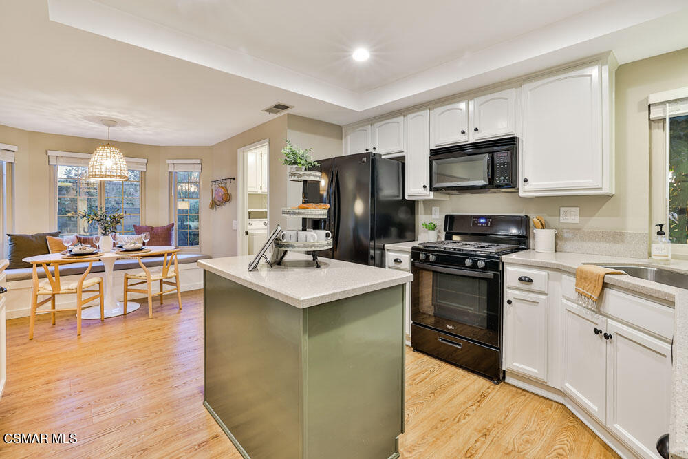 13777 Gunsmoke Road Moorpark, CA 93021 - Photo 13 of 42 a kitchen with stainless steel appliances a stove sink microwave and cabinets