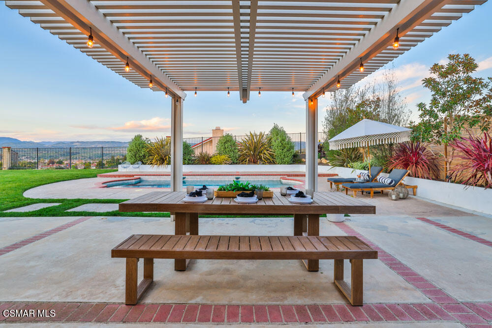 13777 Gunsmoke Road Moorpark, CA 93021 - Photo 28 of 42 a view of a patio with a table and chairs and potted plants