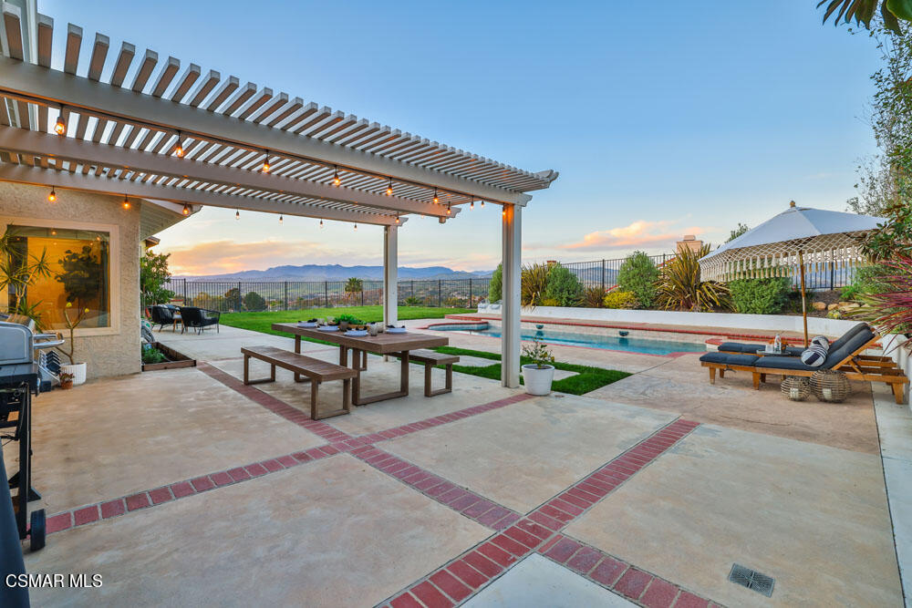 13777 Gunsmoke Road Moorpark, CA 93021 - Photo 29 of 42 a view of a patio with table and chairs potted plants with wooden floor and fence