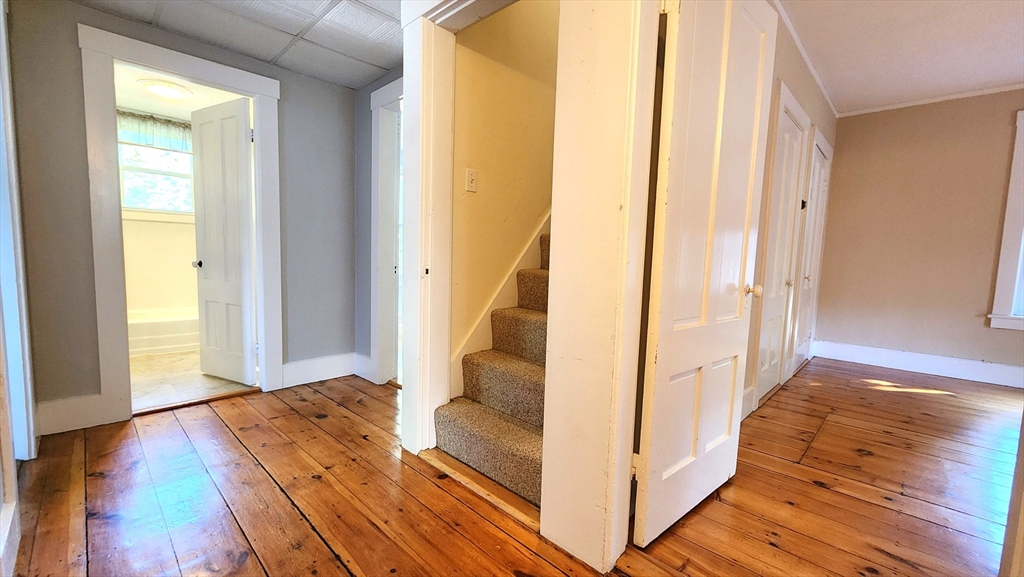 8 Fay Street, Unit 2 Westborough, MA 01581 - Photo 11 of 15 a view of a hallway with wooden floor and staircase