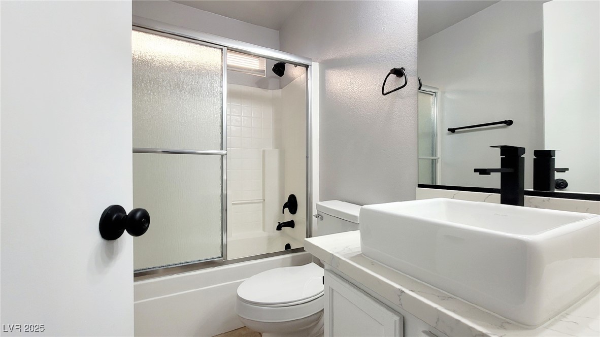 8840 Spinning Wheel Avenue Las Vegas, NV 89143 - Photo 17 of 24 Bathroom with vanity and shower / bath combination with glass door