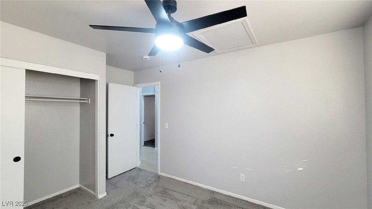 8840 Spinning Wheel Avenue Las Vegas, NV 89143 - Photo 20 of 24 Unfurnished bedroom featuring carpet flooring, a closet, and ceiling fan