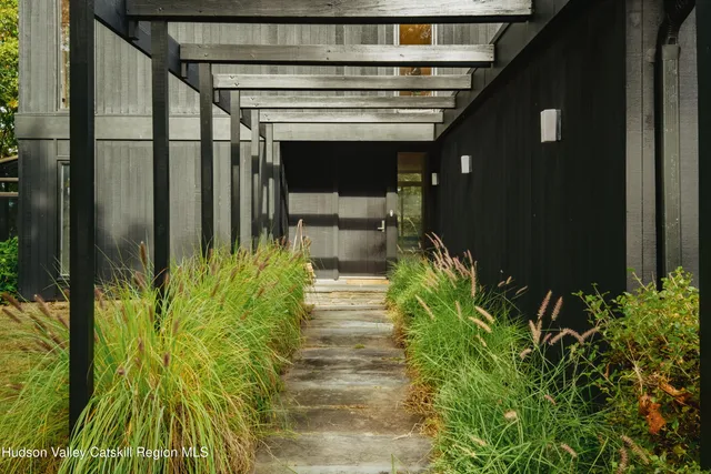 a view of a backyard with plants and a patio