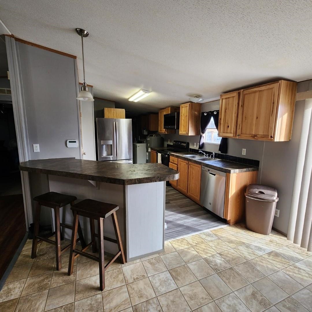 3595 Gainsville Road Mason, TN 38049 - Photo 11 of 28 a kitchen with stainless steel appliances granite countertop a stove a sink dishwasher and a refrigerator