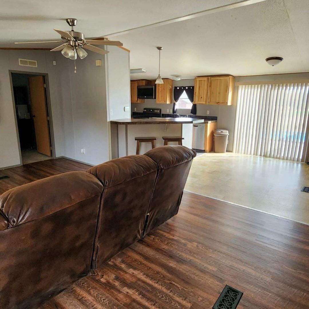 3595 Gainsville Road Mason, TN 38049 - Photo 14 of 28 a living room with a couch and a chandelier
