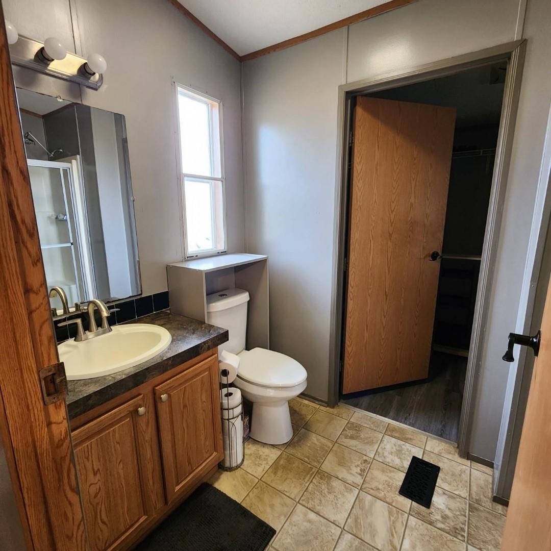 3595 Gainsville Road Mason, TN 38049 - Photo 17 of 28 a bathroom with a sink toilet and mirror