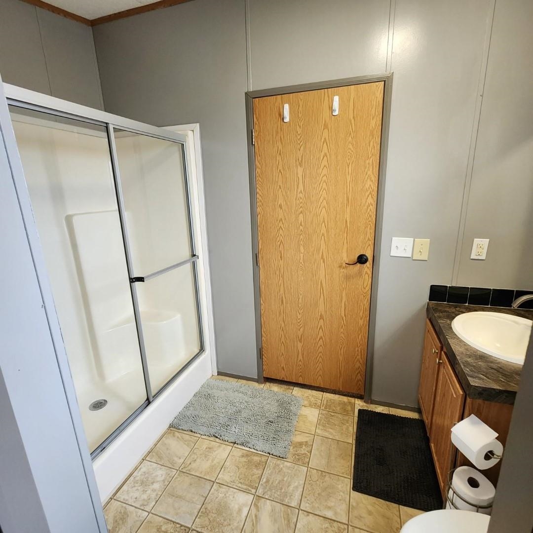 3595 Gainsville Road Mason, TN 38049 - Photo 19 of 28 a bathroom with a sink a toilet and a shower