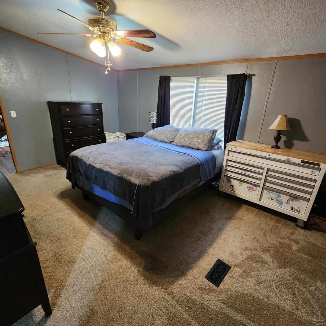 3595 Gainsville Road Mason, TN 38049 - Photo 21 of 28 a bedroom with a bed and a chandelier