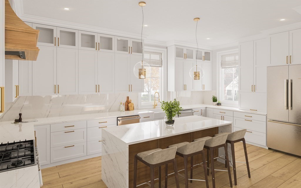 a kitchen with a sink a refrigerator and white cabinets