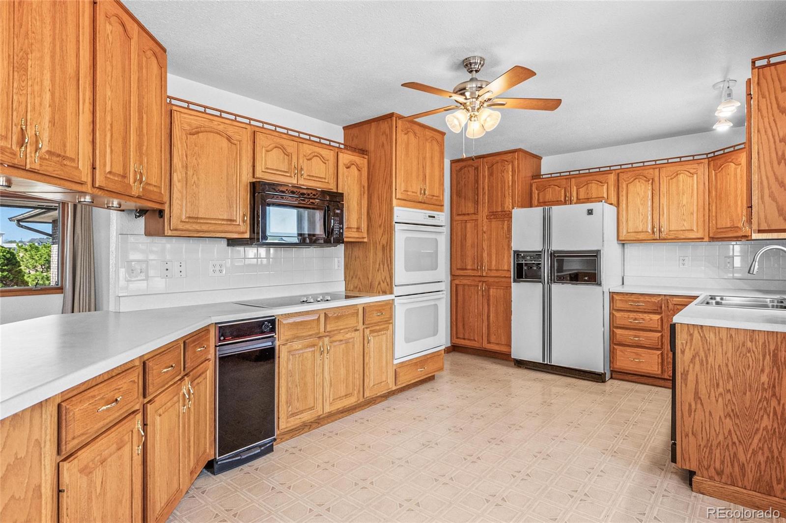 55 Cook Court Hudson, CO 80642 - Photo 12 of 50 a kitchen with stainless steel appliances granite countertop a refrigerator sink and stove
