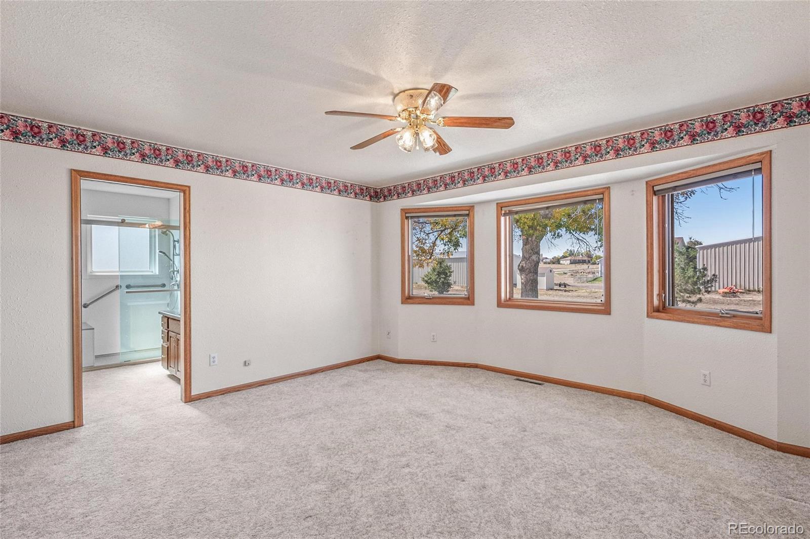 55 Cook Court Hudson, CO 80642 - Photo 15 of 50 an empty room with windows and fan