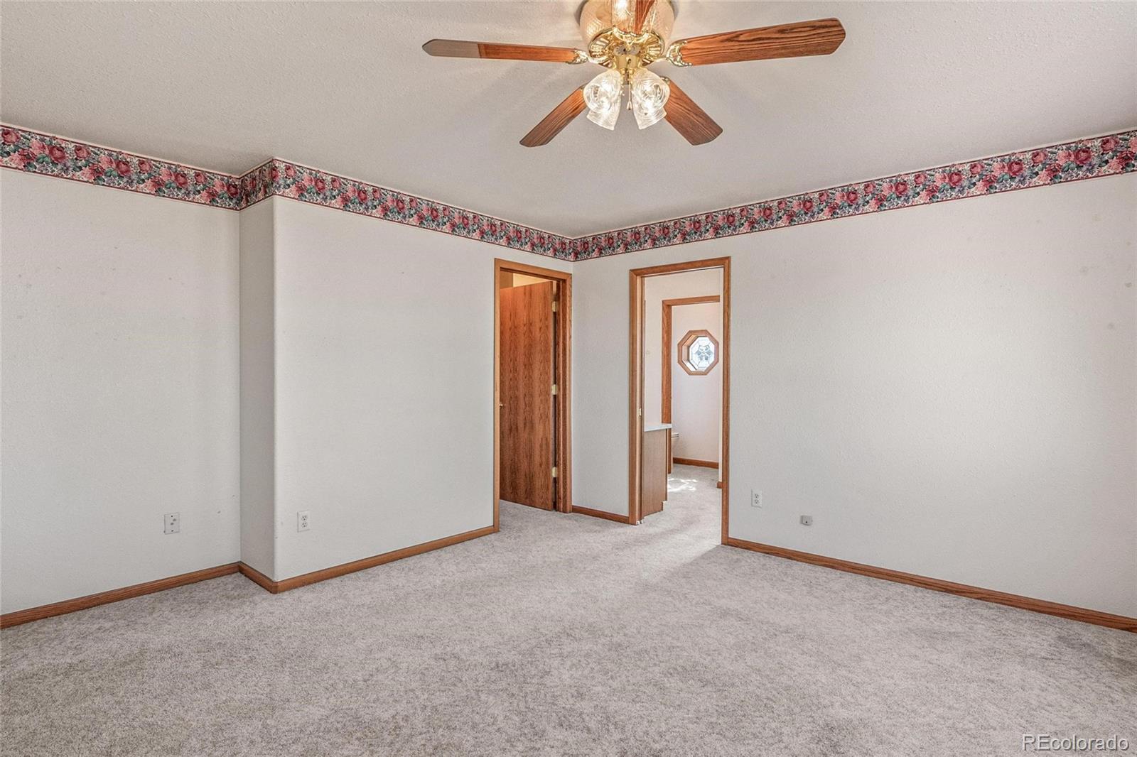 55 Cook Court Hudson, CO 80642 - Photo 16 of 50 a view of empty room with window and ceiling fan