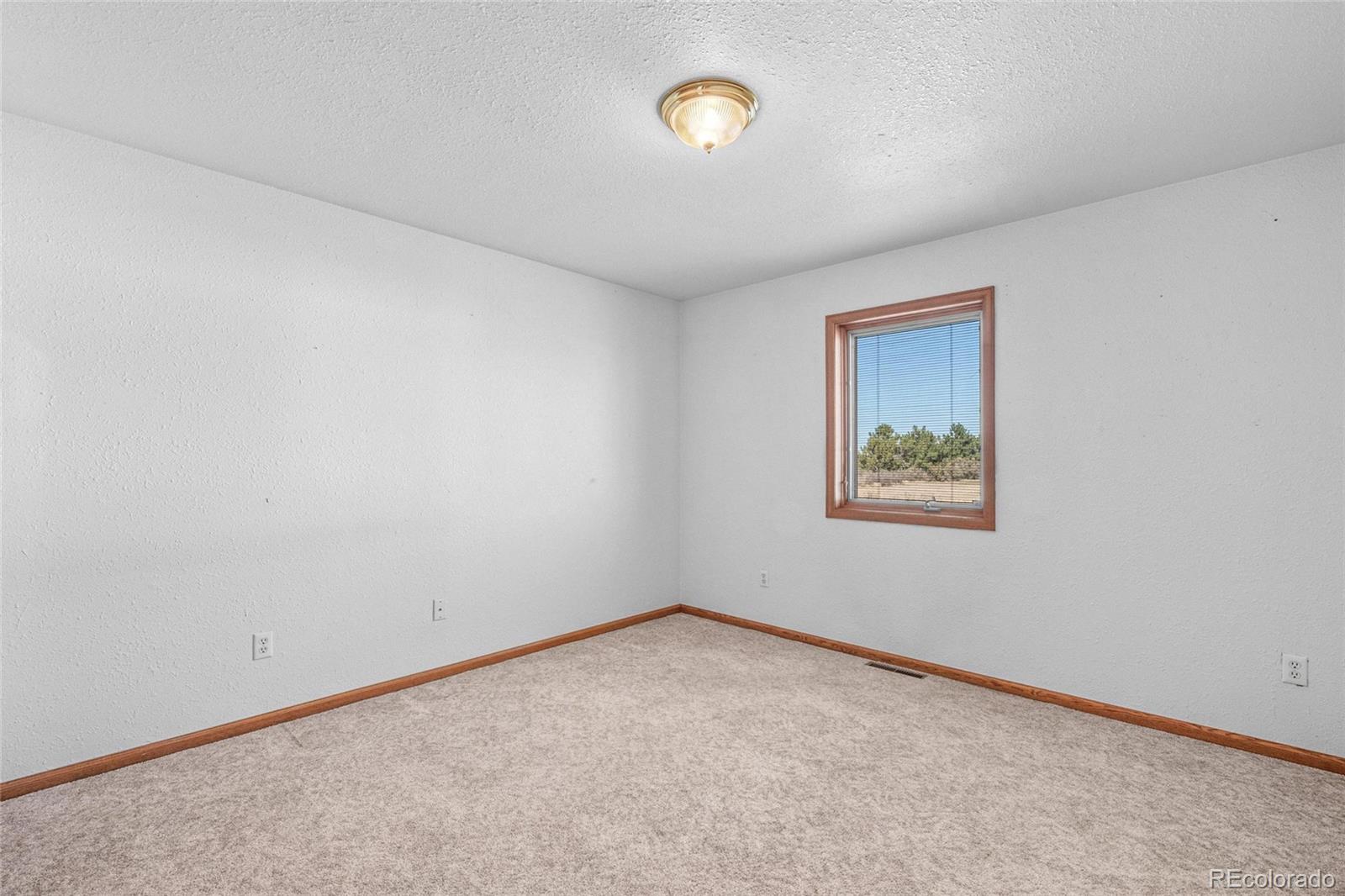 55 Cook Court Hudson, CO 80642 - Photo 23 of 50 an empty room with a window