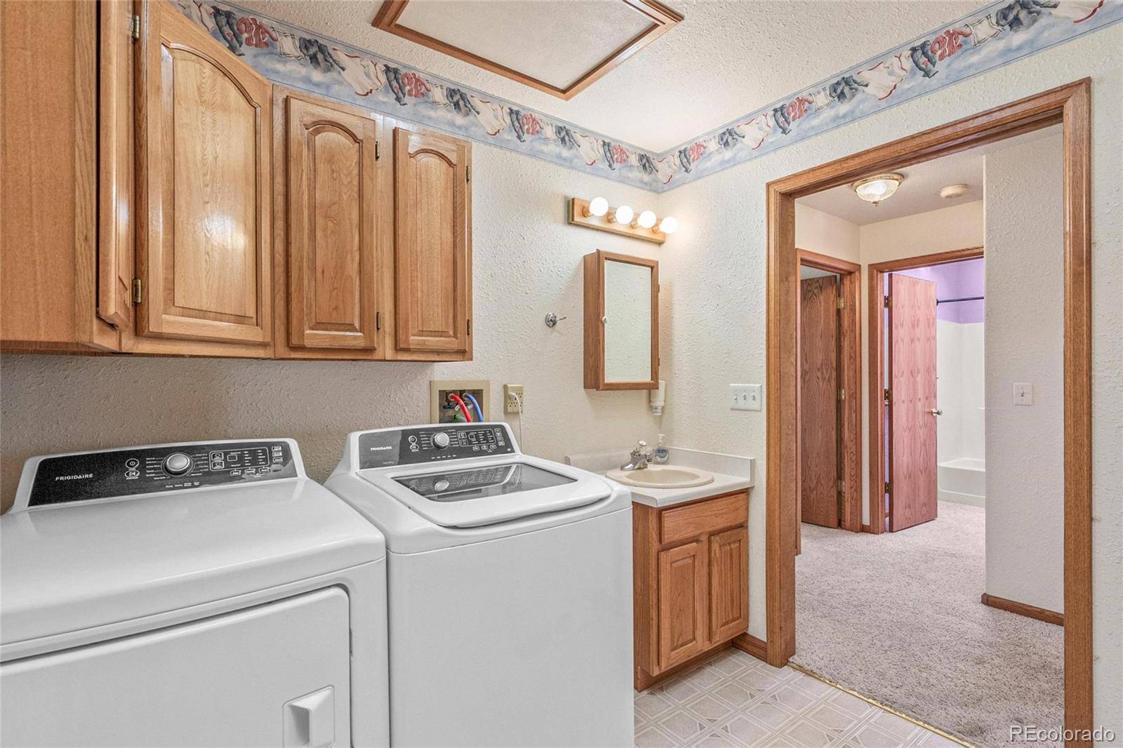 55 Cook Court Hudson, CO 80642 - Photo 26 of 50 a utility room with dryer and washer