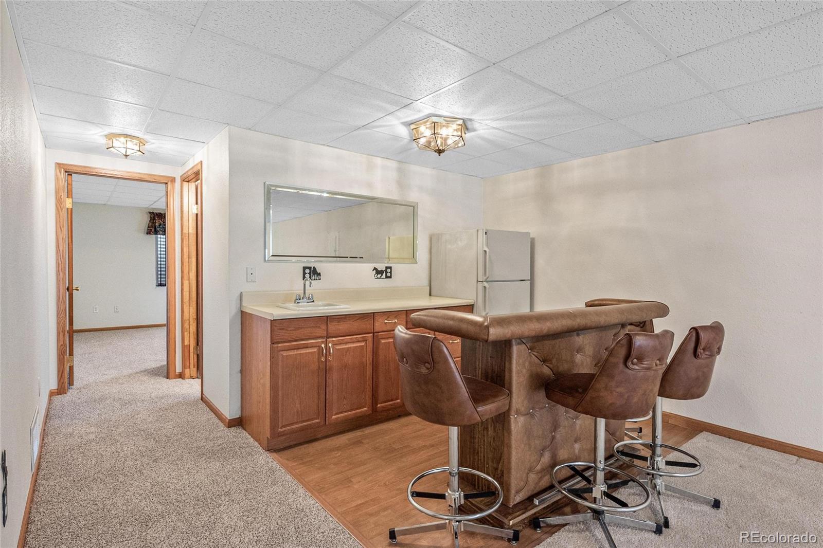 55 Cook Court Hudson, CO 80642 - Photo 31 of 50 a view of a kitchen and dining area with chandelier