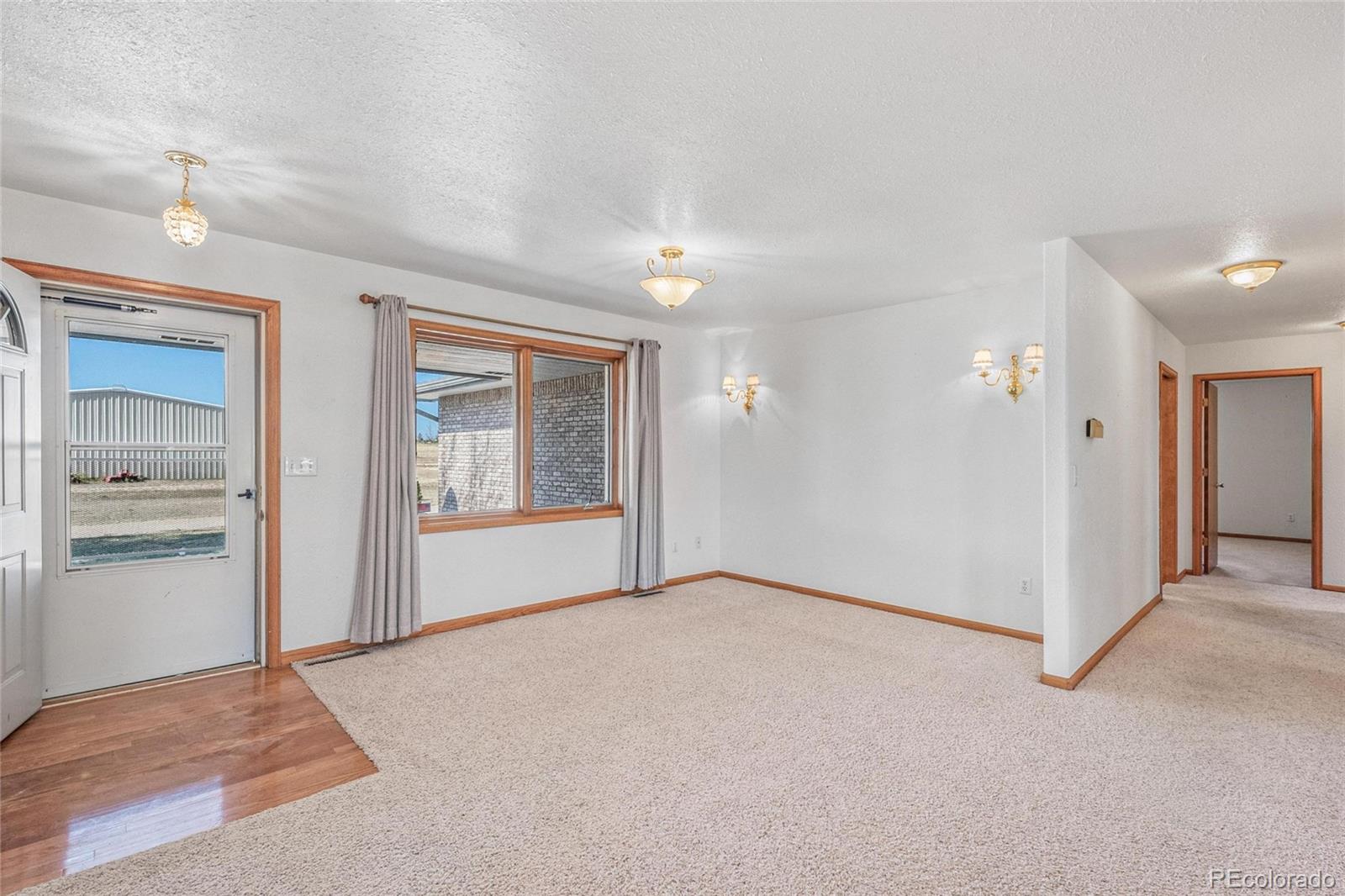55 Cook Court Hudson, CO 80642 - Photo 4 of 50 a view of an empty room with window and cabinet