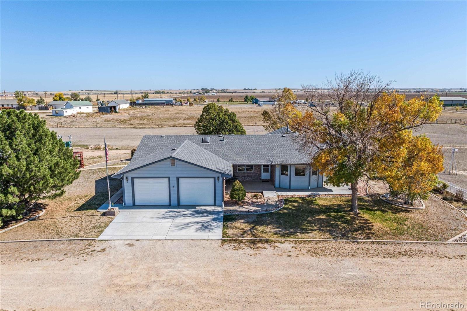 55 Cook Court Hudson, CO 80642 - Photo 44 of 50 a front view of a house with a yard