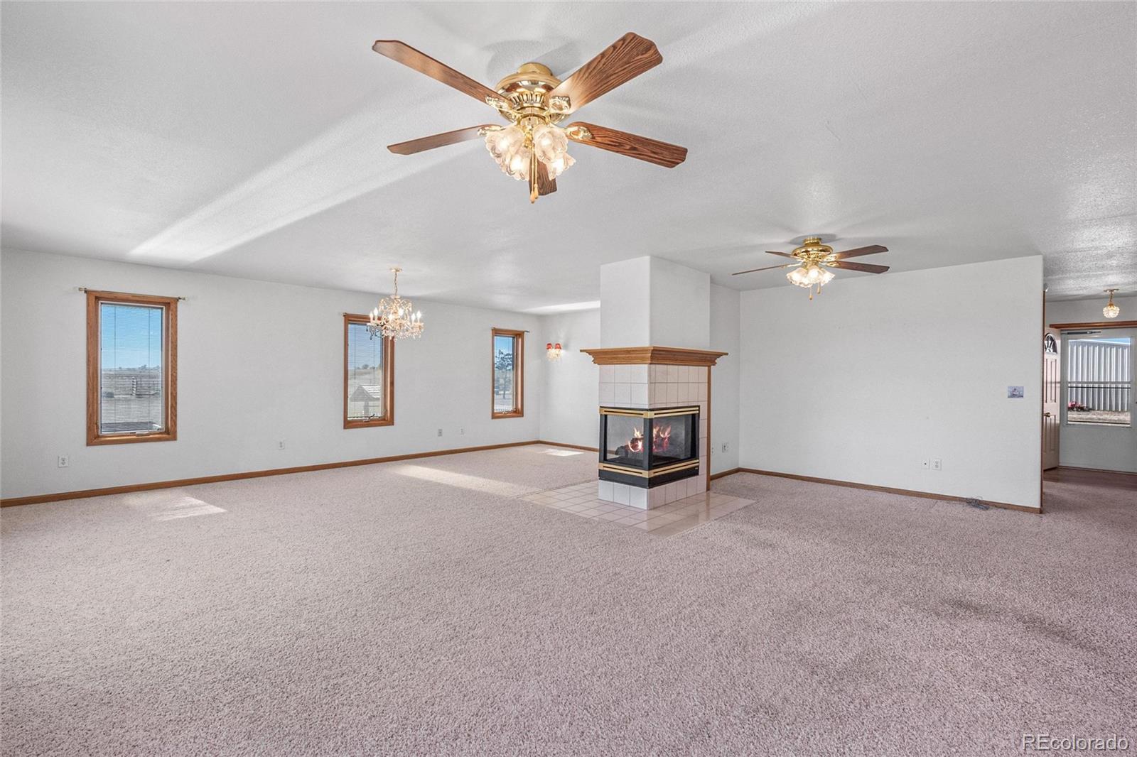 55 Cook Court Hudson, CO 80642 - Photo 7 of 50 a view of a livingroom with a furniture and a ceiling fan