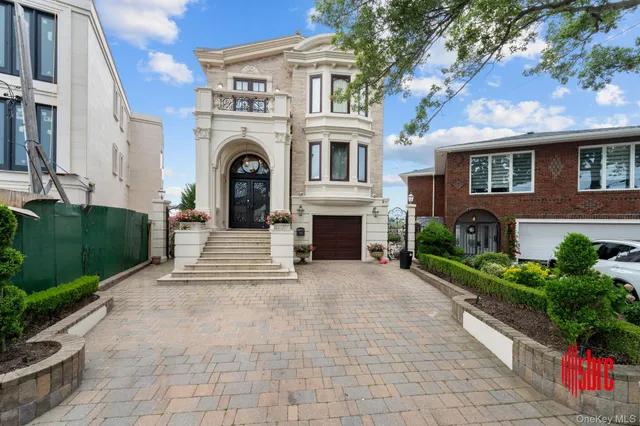 a front view of a house with yard and parking