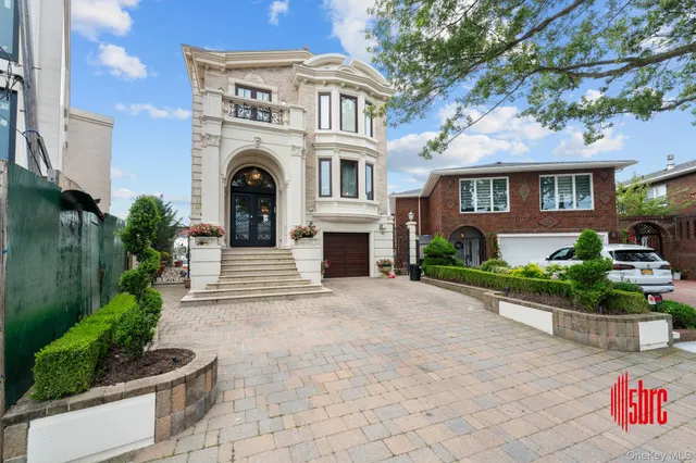 a front view of a house with a garden and plants