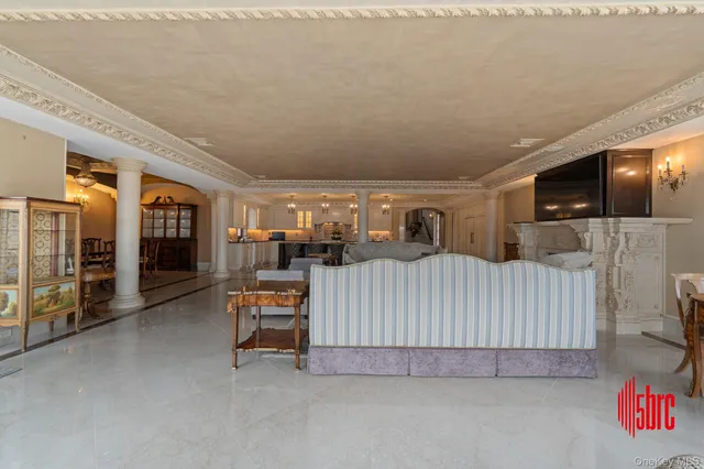 a living room with furniture chandelier and a fireplace